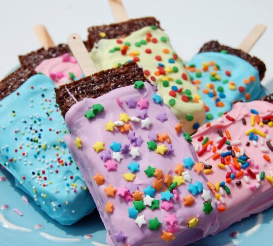 a plate of brightly colored popsicle brownies