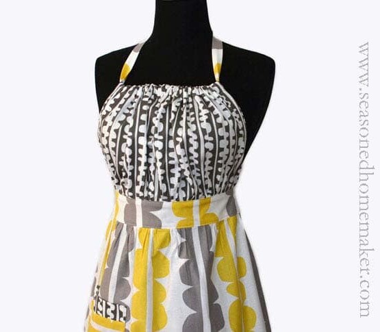 a grey and yellow fabric apron on a mannequin