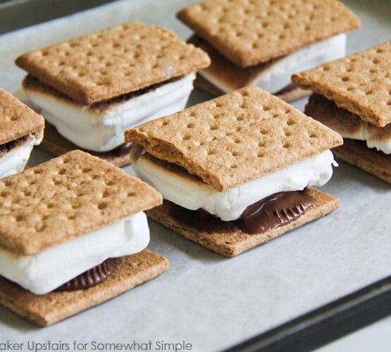 a baking sheet filled will oven baked S'mores that were made inside