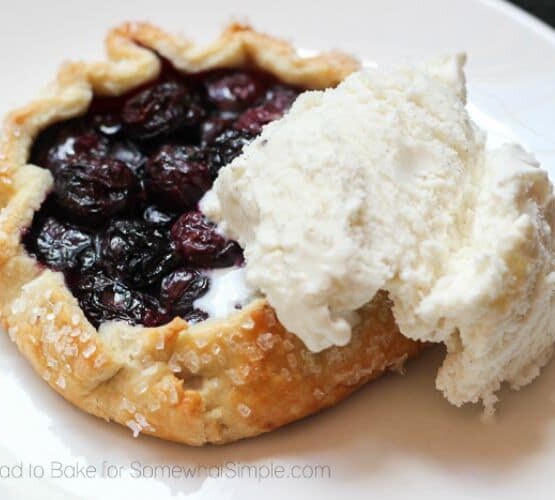 a Blueberry Galette on a plate topped with a scoop of vanilla ice cream