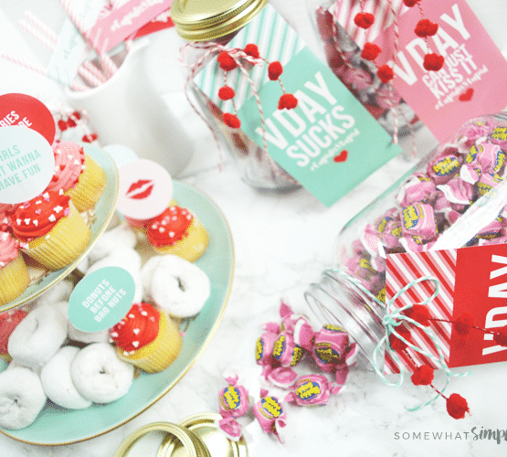 setting up a galentines day party with colorful printables and mini donuts