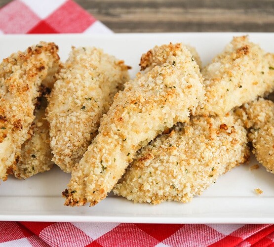 a serving dish filled with homemade Crispy Chicken Fingers