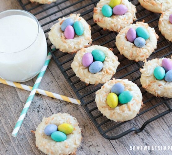 Birds Nest Cookies next to a glass of milk with two paper straws