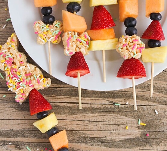 easter snacks - Rice Krispies cut out for easter with sprinkles and fresh fruit on a stick