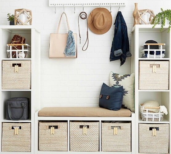 various wooden shelves with bins inside each compartment for storage