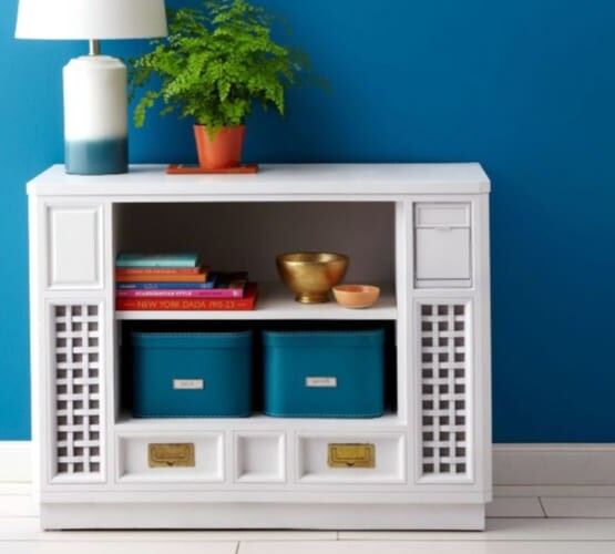 an upcycled tv cabinet turned into a shelf with baskets