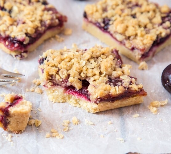 squares of Cherry Streusel Bars on a baking sheet