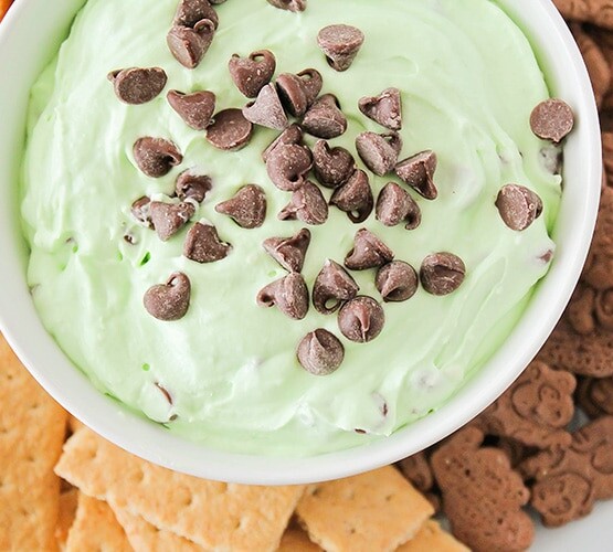 looking down on a bowl of green mint Cheesecake Dip topped with chocolate chips