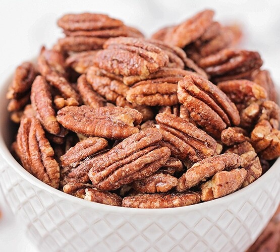 a bowl filled with candied pecans