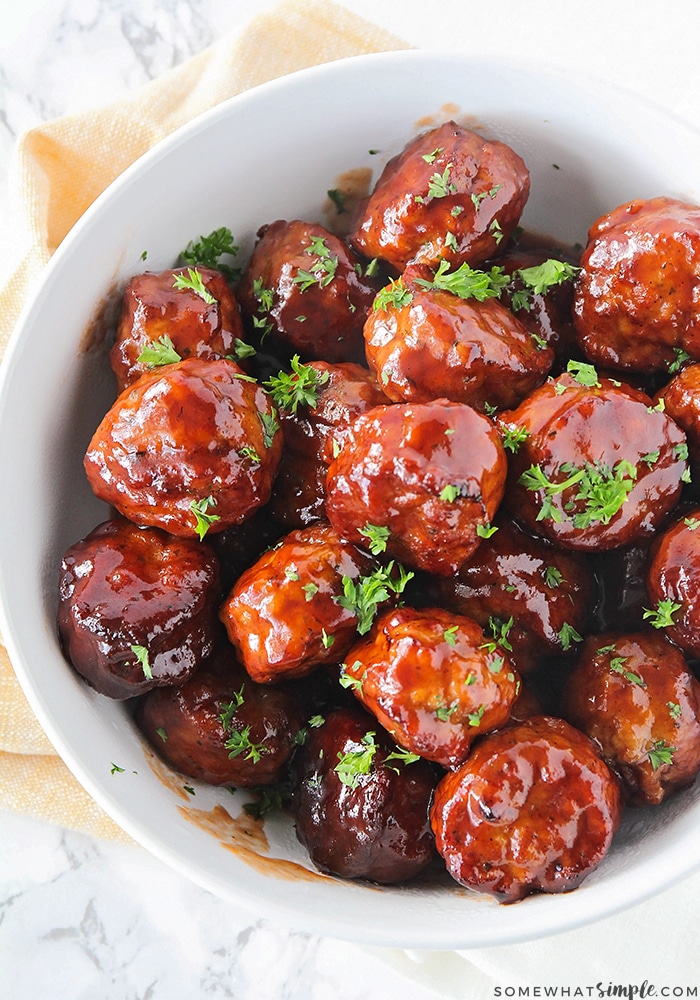 white bowl full of meatballs made with grape jelly
