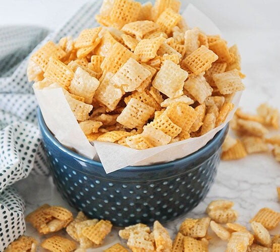 sweet Chex mix recipe in a dark blue bowl