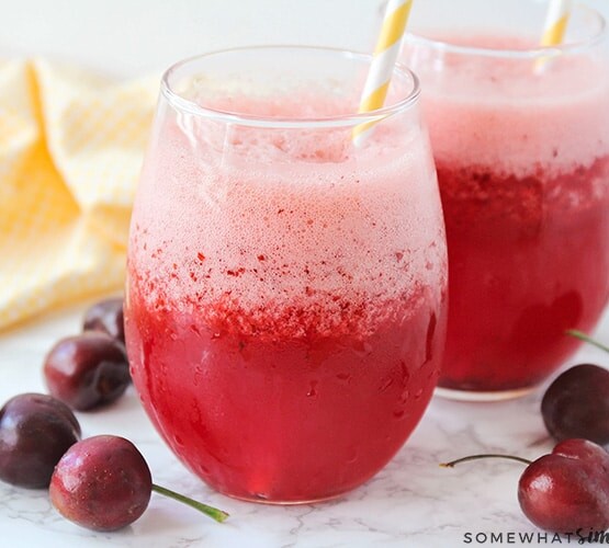 two glasses filled with a frozen cherry lemonade slush