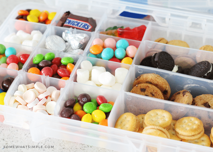 Turn a plastic organizer box into a road trip snack tray filled with a mix  of tasty treats. It's a simple trick to pack …
