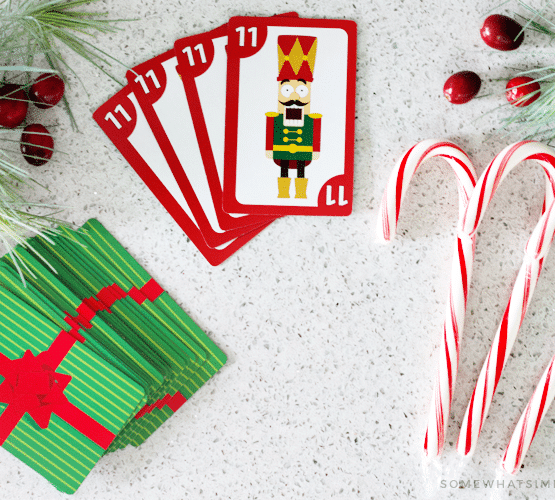 looking down on a deck of cards and candy canes which are used to play this fun variation of the spoons card game.