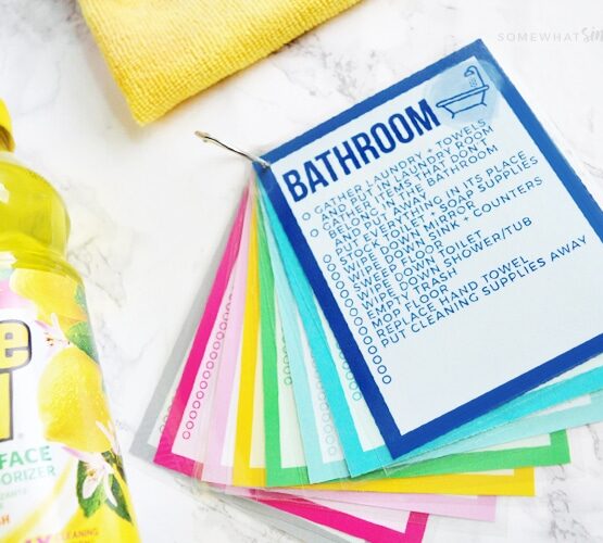 printable cleaning cards next to cleaning supplies