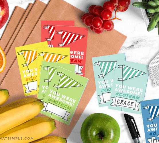 different colored team snack bag printables spread out on the counter