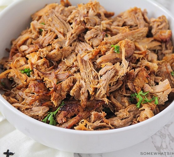 a bowl filled with shredded pulled pork that was made in an instant pot