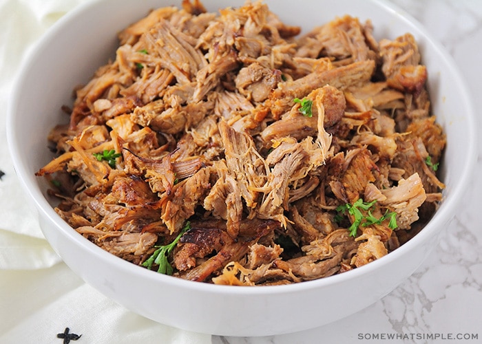 a bowl filled with shredded pulled pork that was made in an instant pot