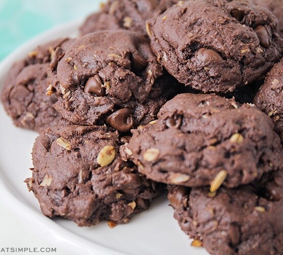 a pile of devils food cake mix cookies on a white cake stand