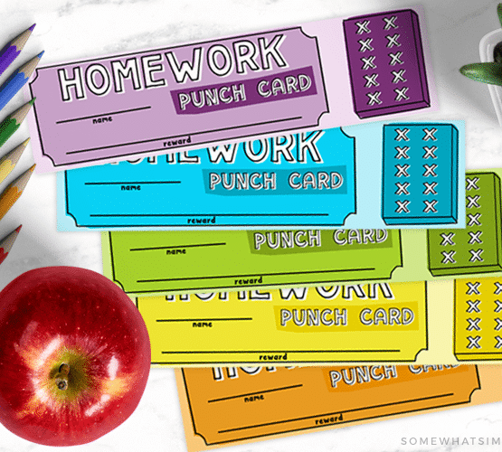 looking down on a purple, blue, green, yellow and orange homework punch card that can also be used as a bookmark