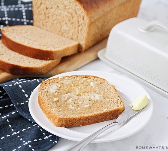 a slice of homemade wheat bread topped with butter