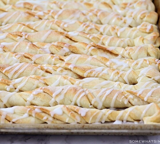 cinnamon bread twists with icing drizzled over the top