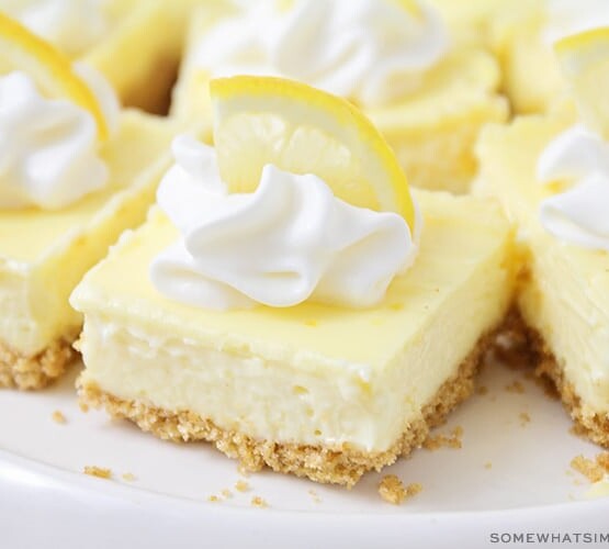 lemon cheesecake squares topped with whipped cream