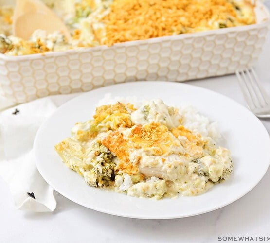 A plate full of chicken divan with a casserole dish full of this easy recipe in the background
