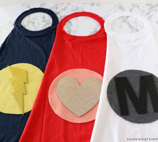 cute logos on the back of 3 superhero capes for kids