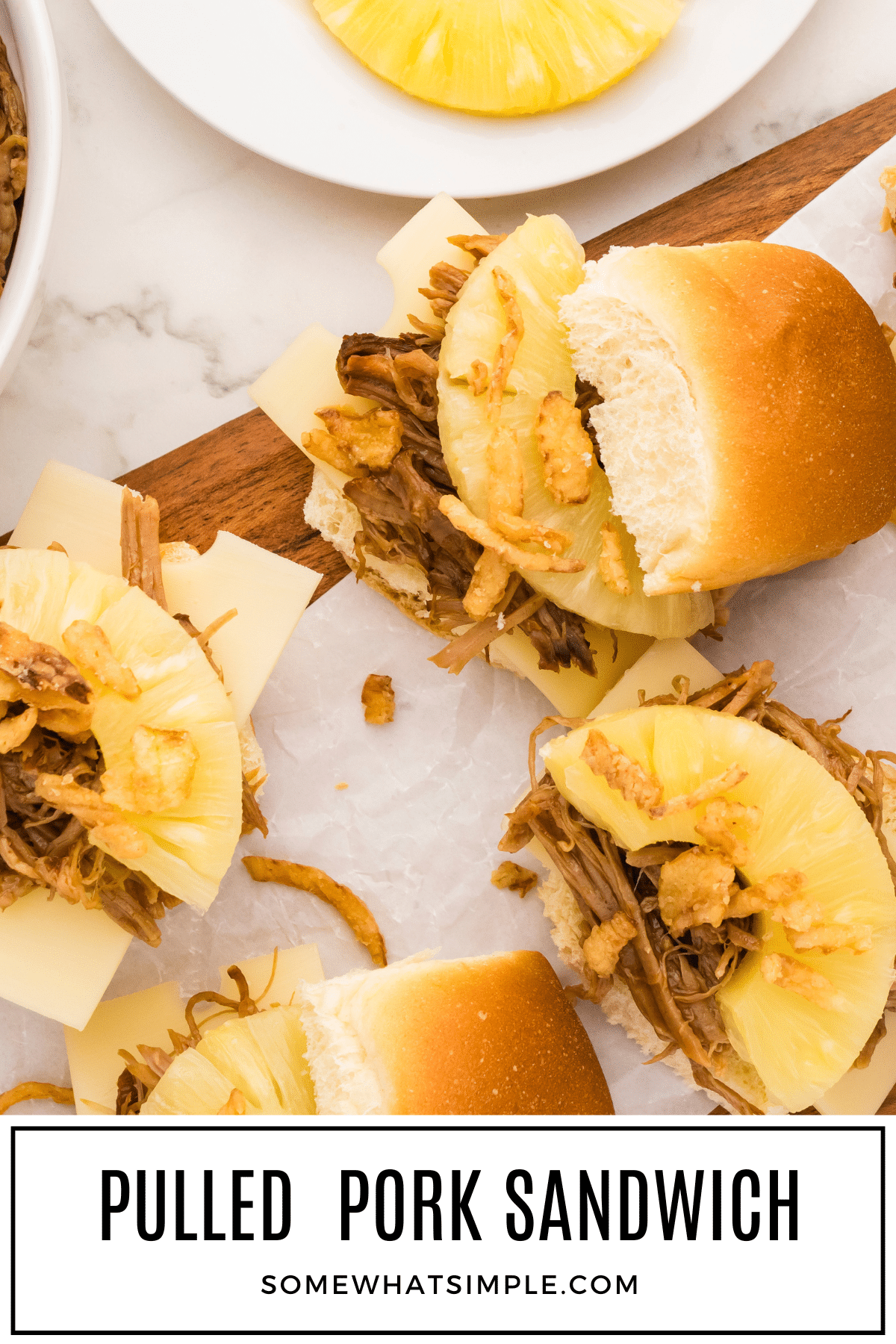 Tender meat piled on Hawaiian rolls, topped with pineapple, cheese, and crunchy fried onions make the BEST Hawaiian Pulled Pork Sandwiches! via @somewhatsimple