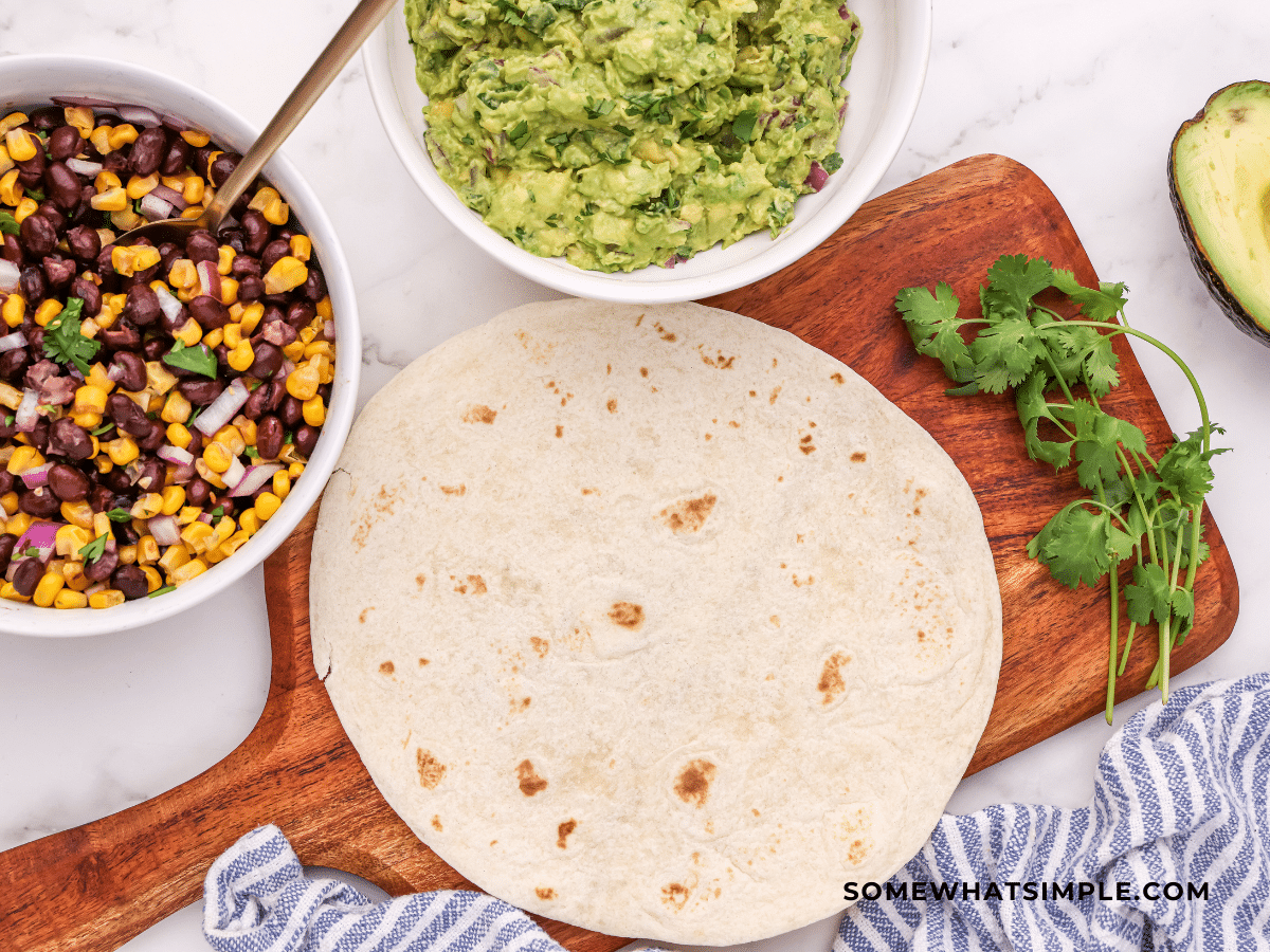 empty tortilla with Vegan Tacos ingredients next to it